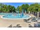 Community pool area with a splashpad, lounge chairs, and tables and chairs at 17204 Caldwell Track Dr, Huntersville, NC 28078