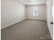 Carpeted bedroom featuring a large window and neutral color scheme at 1723 Loggerhead Dr, Lancaster, SC 29720