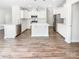 Modern white kitchen with stainless steel appliances, center island, and ample cabinet space at 1723 Loggerhead Dr, Lancaster, SC 29720