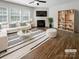Cozy living room with a fireplace, large windows, modern furniture, and stylish decor at 1723 Loggerhead Dr, Lancaster, SC 29720