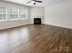 Bright living room with a fireplace, hardwood floors, and large windows at 1723 Loggerhead Dr, Lancaster, SC 29720