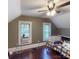 Attic bedroom with slanted ceilings, hardwood floors, natural light, and a ceiling fan at 208 N 5Th St, Albemarle, NC 28001