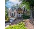Charming home with stone accents, dormer windows, and a well-maintained yard and stairs to the entrance at 208 N 5Th St, Albemarle, NC 28001