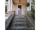 Inviting front entrance with stone stairs and pillars leading to the front door of the home at 208 N 5Th St, Albemarle, NC 28001
