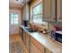 Functional kitchen featuring laminate countertops, stainless steel sink, and light colored cabinets at 208 N 5Th St, Albemarle, NC 28001