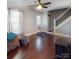 Hardwood floors, staircase, and a ceiling fan make this room a comfortable place to relax at 208 N 5Th St, Albemarle, NC 28001