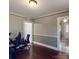 A well-lit office space showcasing dark wood floors, neutral wall colors, and direct hallway access at 208 N 5Th St, Albemarle, NC 28001