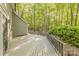 Back deck overlooking a leafy wooded area, providing privacy and natural beauty at 2310 Vestry Pl, Charlotte, NC 28270