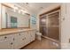 Bathroom featuring a sink vanity with drawers and a glass-enclosed shower stall at 2310 Vestry Pl, Charlotte, NC 28270