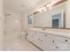 Bright white bathroom with shower-tub combo, window, and long vanity at 2310 Vestry Pl, Charlotte, NC 28270