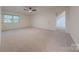 Spacious bedroom with neutral carpeting, window, ceiling fan, and attached room at 2310 Vestry Pl, Charlotte, NC 28270
