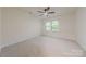 Bright, carpeted bedroom with fan and double window overlooking backyard at 2310 Vestry Pl, Charlotte, NC 28270