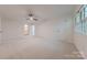 Large bedroom with carpeting, ceiling fan, two windows, and closet at 2310 Vestry Pl, Charlotte, NC 28270