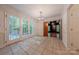 Sun-drenched breakfast area features tile floors, glass paneled doors to the outdoor patio, and wood trim at 2310 Vestry Pl, Charlotte, NC 28270