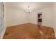 Dining room features hardwood floors, soft neutral walls, and a view into the adjacent kitchen at 2310 Vestry Pl, Charlotte, NC 28270
