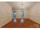 Spacious dining room with hardwood floors, crown molding, and large windows for natural light at 2310 Vestry Pl, Charlotte, NC 28270
