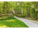 Long driveway leads to a charming home surrounded by lush greenery and mature trees at 2310 Vestry Pl, Charlotte, NC 28270