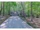 A lovely two-story home featuring an attached garage, surrounded by beautiful trees and a long driveway at 2310 Vestry Pl, Charlotte, NC 28270