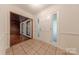 Bright foyer featuring tile flooring and natural light, creating a warm and welcoming entrance to the home at 2310 Vestry Pl, Charlotte, NC 28270