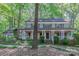 Charming two-story home with a welcoming front porch, surrounded by lush landscaping and mature trees at 2310 Vestry Pl, Charlotte, NC 28270