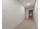 Upstairs hallway with neutral carpet and white walls leading to bedrooms at 2310 Vestry Pl, Charlotte, NC 28270