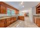 Kitchen boasts wood cabinetry, stainless appliances, and granite countertops, with a sun-filled dining area nearby at 2310 Vestry Pl, Charlotte, NC 28270