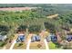 Aerial view of a neighborhood showcasing homes with lush landscaping and mature trees at 2396 Lee Lawing Rd, Lincolnton, NC 28092