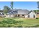 Spacious backyard featuring a well-maintained lawn and a covered patio with stylish columns at 2396 Lee Lawing Rd, Lincolnton, NC 28092