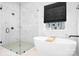 Spa-like bathroom featuring a soaking tub, a separate shower with glass door, and a large window at 2396 Lee Lawing Rd, Lincolnton, NC 28092