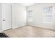 Bright, empty bedroom with two windows, light-colored walls, and sleek light wood flooring at 2396 Lee Lawing Rd, Lincolnton, NC 28092