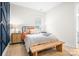 Comfortable bedroom featuring a metal bed frame, wooden bench, and light wood flooring at 2396 Lee Lawing Rd, Lincolnton, NC 28092