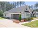 Charming home exterior with a well-maintained lawn and beautiful flowerbeds at 2396 Lee Lawing Rd, Lincolnton, NC 28092