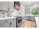 Modern kitchen boasts stainless steel appliances, stylish tile backsplash, and ample cabinet space at 2396 Lee Lawing Rd, Lincolnton, NC 28092