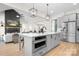 Elegant kitchen featuring a large island, stainless steel appliances, and open access to the living room at 2396 Lee Lawing Rd, Lincolnton, NC 28092