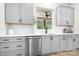 Bright kitchen featuring stainless steel appliances, grey cabinets, and a window overlooking the outdoors at 2396 Lee Lawing Rd, Lincolnton, NC 28092
