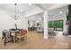 Open concept living space with modern furnishings, hardwood floors, and large windows with backyard view at 2396 Lee Lawing Rd, Lincolnton, NC 28092