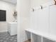 Practical mud room with built-in coat rack and bench, along with a stylish patterned floor at 2396 Lee Lawing Rd, Lincolnton, NC 28092