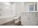 Clean bathroom with a tub, toilet, and white vanity with storage at 2405 Hedgecliff Rd, Kannapolis, NC 28025