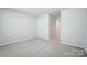 Spacious bedroom with neutral walls and carpet, and a view into the hallway at 2405 Hedgecliff Rd, Kannapolis, NC 28025