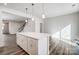 Quartz kitchen island with pendant lighting, modern cabinets, and stainless steel appliances at 2405 Hedgecliff Rd, Kannapolis, NC 28025