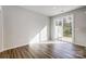 Bright, open-concept living space with wood-look flooring and sliding glass doors to the outside at 2405 Hedgecliff Rd, Kannapolis, NC 28025