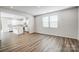 Bright living space with luxury vinyl plank flooring adjoins a modern kitchen with an island at 2405 Hedgecliff Rd, Kannapolis, NC 28025