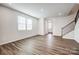 Spacious living room features luxury vinyl plank flooring and natural light from large windows at 2405 Hedgecliff Rd, Kannapolis, NC 28025
