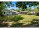 Spacious backyard with healthy green grass, patio area, and privacy fence at 2635 Clover Hill Ln, Charlotte, NC 28215