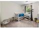 This Bedroom features a crib, changing table, carpeted floors, and natural light at 2635 Clover Hill Ln, Charlotte, NC 28215
