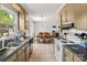 Bright kitchen and dining area featuring tile flooring and stainless steel appliances at 2635 Clover Hill Ln, Charlotte, NC 28215