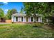 Charming single-story home featuring a welcoming front porch, light blue siding, and well-maintained lawn at 2635 Clover Hill Ln, Charlotte, NC 28215