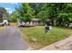 Charming single-story home with a well-manicured lawn, mature trees, and a classic mailbox, creating inviting curb appeal at 2635 Clover Hill Ln, Charlotte, NC 28215