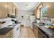 Functional kitchen featuring tile floors, black appliances, and ample countertop space at 2635 Clover Hill Ln, Charlotte, NC 28215