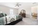 This bedroom features neutral carpeting, large window, and a ceiling fan at 2754 Legacy Ridge Ln, Catawba, NC 28609
